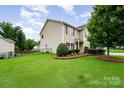 Well-maintained lawn with partial fence on a charming two-story home at 611 Sawtooth Oak Dr, Landis, NC 28088