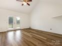 Spacious living room features high ceilings, light wood flooring and French doors leading outside at 7006 Lone Eagle Dr # 18, Monroe, NC 28110