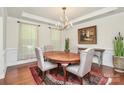 Elegant dining room features hardwood floors, a stylish chandelier, and ample space for entertaining at 7011 Hyde Park Dr, Indian Trail, NC 28079