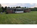 Spacious backyard featuring a screen porch and shed provides outdoor living at 711 Burtonwood Ln, Lincolnton, NC 28092
