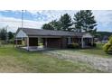 Relaxing brick home boasts a carport and a cozy front porch in a peaceful setting at 711 Burtonwood Ln, Lincolnton, NC 28092