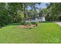 Charming home nestled amongst mature trees, boasting a well-maintained lawn, and classic design at 848 Ike Lynch Rd, Dallas, NC 28034