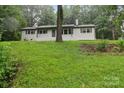Classic brick home with a well-kept lawn and mature tree creating a serene setting at 848 Ike Lynch Rd, Dallas, NC 28034