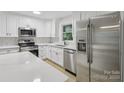 Modern kitchen featuring stainless steel appliances, white cabinets, and light countertops at 848 Ike Lynch Rd, Dallas, NC 28034