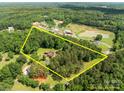Expansive aerial view showcasing the home, surrounding acreage and outlining property lines at 885 Roy Cline Rd, Rockwell, NC 28138