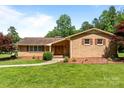 Inviting brick home with a manicured lawn, complemented by a well-designed walkway leading to the front entrance at 885 Roy Cline Rd, Rockwell, NC 28138