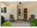 Inviting front porch with seating, showcasing a cozy entrance to the home at 110 Whitehall Dr, Mooresville, NC 28117