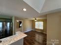 Open concept living area with hardwood floors, ceiling fan and lots of natural light at 110 Whitehall Dr, Mooresville, NC 28117