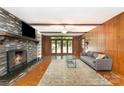 Spacious living room with a stone fireplace and access to a large deck at 1107 Fairfield Dr, Gastonia, NC 28054