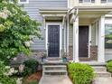Inviting townhome entrances with stone accents, flowering bushes, and dark doors at 1132 Whitby Moore St, Charlotte, NC 28273