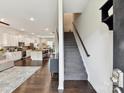 Open-concept floor plan with staircase, hardwood floors, and easy access to the kitchen at 1132 Whitby Moore St, Charlotte, NC 28273