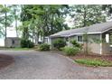 Inviting exterior of a home featuring well-maintained landscaping and a gravel driveway leading to the house at 114 Caraway Ln, Mooresville, NC 28117