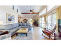 Bright living room with vaulted ceilings, large windows, comfortable seating, and elegant tile flooring at 114 Caraway Ln, Mooresville, NC 28117