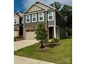 Beautiful townhome with manicured lawn and attractive landscaping at 12301 Gambrell Dr, Charlotte, NC 28278
