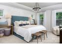 Stylish main bedroom featuring a plush bed, accent wall, and ample natural light at 12301 Gambrell Dr, Charlotte, NC 28278