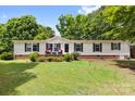 Inviting single-story home with well-maintained lawn and charming front porch at 125 Brasington Ln, Mooresville, NC 28115