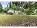 Charming single-story home with a detached garage on a spacious lot at 125 Brasington Ln, Mooresville, NC 28115