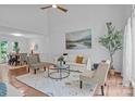 Open-concept living room with hardwood floors, neutral decor, and plenty of natural light at 12524 Angel Oak Dr, Huntersville, NC 28078