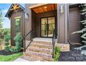 Inviting front entrance showcasing a wood trimmed porch and glass front door with brick stairs at 130 Broken Arrow Dr, Statesville, NC 28677