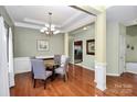 Elegant dining room with hardwood floors, chandelier, and views to the kitchen at 13247 Eastfield Village Ln, Charlotte, NC 28269