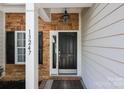 Close-up of the front door with stone accents and a welcoming entrance at 13247 Eastfield Village Ln, Charlotte, NC 28269