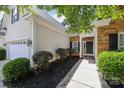 Well-maintained home with stone accents, mature shrubs, and inviting walkway at 13247 Eastfield Village Ln, Charlotte, NC 28269
