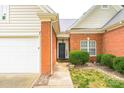 Close up of the home's brick exterior, front door and attached two-car garage at 13402 Mccoy Rd, Huntersville, NC 28078