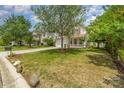 A pleasant view of a two-story home with a manicured lawn, showcasing its charming curb appeal and welcoming facade at 13622 Stringfellow Ln, Charlotte, NC 28278