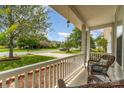 Relaxing front porch with wicker chairs, offering a tranquil view of the landscaped yard and quiet neighborhood street at 13622 Stringfellow Ln, Charlotte, NC 28278
