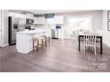 Bright kitchen with stainless steel appliances, island with bar stool seating, and an adjacent dining area at 147 Commerce Blvd # 0003, Lancaster, SC 29720