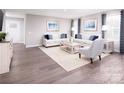 Cozy living room featuring hardwood floors, neutral decor, and large windows with stylish curtains at 147 Commerce Blvd # 0003, Lancaster, SC 29720