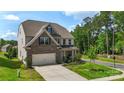 Charming two-story home with landscaped yard, paved driveway, and lush green trees at 17637 Snug Harbor Rd, Charlotte, NC 28278