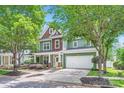Charming two-story home with green siding, wood accents, and a well-maintained front yard at 18732 Coachmans Trce, Cornelius, NC 28031