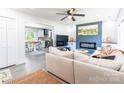 Open floor plan featuring light gray flooring, cozy fireplace with blue accent wall at 2116 Eastway Dr, Charlotte, NC 28205