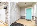 Stylish front entrance featuring a turquoise door, stone accents, and gray siding at 2116 Morgan Hills Dr, Albemarle, NC 28001