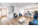 Bright living room featuring an open floor plan, hardwood floors, and modern furnishings at 2116 Morgan Hills Dr, Albemarle, NC 28001