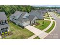 Aerial view of single-Gathering home with a two-car garage, manicured lawn, and welcoming front porch at 218 Tetcott St, Mooresville, NC 28115