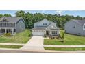 Charming single-Gathering home with a two-car garage, manicured lawn, and welcoming front porch at 218 Tetcott St, Mooresville, NC 28115