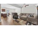 Bright living room featuring hardwood floors, a ceiling fan, and an open layout to the dining area at 237 River Clay Rd, Fort Mill, SC 29708