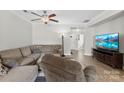 Comfortable living room with hardwood floors, ceiling fan, and a view leading towards the front door at 237 River Clay Rd, Fort Mill, SC 29708