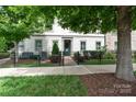 Charming two-story home with a manicured front yard, complemented by a black fence and mature trees at 2514 Marshall Pl, Charlotte, NC 28203