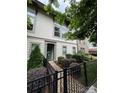 Beautiful two-story townhouse with manicured landscaping, a brick walkway, and a secure wrought iron fence at 2514 Marshall Pl, Charlotte, NC 28203