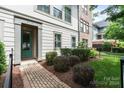Inviting home exterior features a brick walkway, lush landscaping and a charming green front door at 2514 Marshall Pl, Charlotte, NC 28203