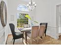 Dining area with natural light from large window, chandelier, and stylish decor, making for comfortable meals at 3831 Riceland Pl, Charlotte, NC 28216