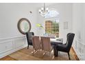 Sunlit dining room with elegant chandelier and stylish decor at 3831 Riceland Pl, Charlotte, NC 28216