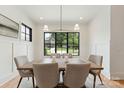 Bright dining room featuring a wooden table, comfortable chairs, and a view of the neighborhood at 408 Ideal Way, Charlotte, NC 28203
