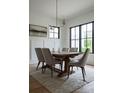 Elegant dining room with a wooden table, comfortable chairs, and a view of the neighborhood at 408 Ideal Way, Charlotte, NC 28203