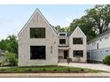 Charming two-story home with elegant white brick, black windows, and landscaped front yard at 408 Ideal Way, Charlotte, NC 28203