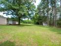 Expansive backyard featuring a lush lawn and a storage shed at the back of the property at 409 Ridge Rd, Clover, SC 29710