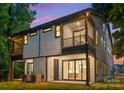 Home back exterior featuring a patio, balcony and large windows offering great views and natural light at 4117 Sarah Dr, Charlotte, NC 28217